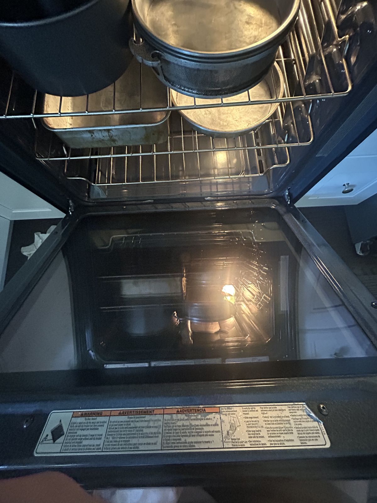 Open gas oven door and racks during an inspection — oven and range repair call in Kingston, WA