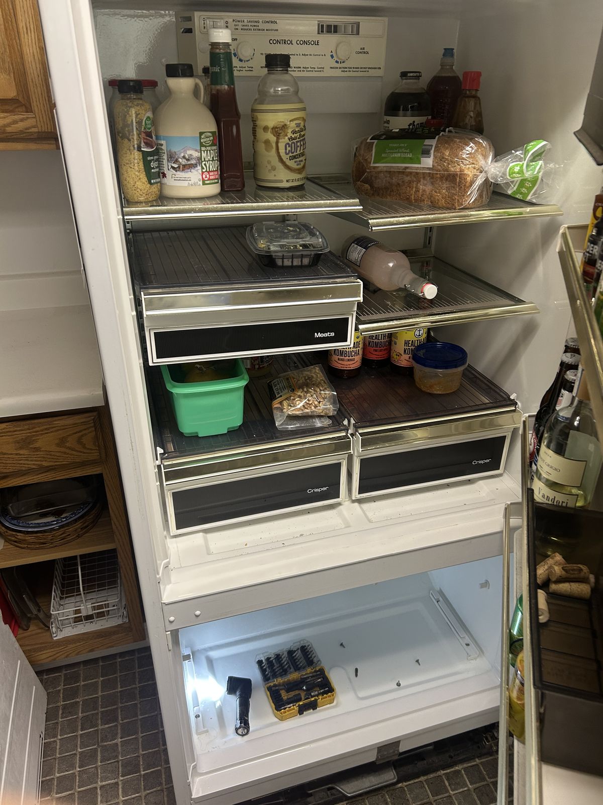 Vintage refrigerator mid-service with freezer open and tools out — refrigerator repair call in Silverdale, WA
